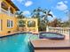 Backyard pool with lounge chairs, a built-in spa, and mature landscaping at 416 Baycrest Dr, Venice, FL 34285