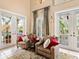 Charming sitting area with elegant chairs, French doors, and abundant natural light overlooking the outdoor spaces at 416 Baycrest Dr, Venice, FL 34285