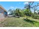 Backyard deck features an umbrella and lounge chairs, overlooking the private yard at 419 Shore Rd, Nokomis, FL 34275