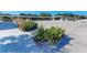 A wide shot of the well-maintained plaza area featuring attractive landscaping and a covered walkway at 419 Shore Rd, Nokomis, FL 34275