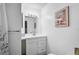 Bright bathroom features a white vanity with storage, a framed mirror, and modern lighting fixtures at 4437 Tippecanoe Trl # 6, Sarasota, FL 34233