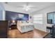 Relaxing main bedroom boasts a blue accent wall, wood floors, and natural light at 4437 Tippecanoe Trl # 6, Sarasota, FL 34233