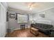 Cozy bedroom with modern gray walls, wood flooring, ceiling fan, and decor at 4437 Tippecanoe Trl # 6, Sarasota, FL 34233