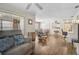 Open-concept living space with wood floors, ceiling fans, and access to the kitchen and dining area at 4437 Tippecanoe Trl # 6, Sarasota, FL 34233
