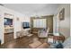 Bright living room with ceiling fan, wood floors, and access to other rooms and outdoor patio at 4437 Tippecanoe Trl # 6, Sarasota, FL 34233