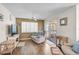 Inviting living room with ceiling fan, wood floors, and sliding doors to the outdoor space at 4437 Tippecanoe Trl # 6, Sarasota, FL 34233