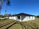 The backyard shows an exterior view of the house featuring sliding glass doors and a concrete patio at 4595 Horseshoe Ave, North Port, FL 34286