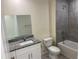 Modern bathroom showcasing granite countertops, white vanity, and a tiled shower-tub combo at 4595 Horseshoe Ave, North Port, FL 34286