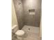 Contemporary bathroom with a tiled shower and modern fixtures, including a water-efficient toilet at 4595 Horseshoe Ave, North Port, FL 34286