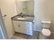 Modern bathroom featuring a granite countertop vanity, mirror, and a toilet at 4595 Horseshoe Ave, North Port, FL 34286