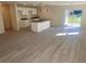 Open-concept living room with modern kitchen, complete with island and sliding glass doors at 4595 Horseshoe Ave, North Port, FL 34286