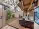 Cozy back patio featuring cushioned seating, wooden deck, and lush green plants for a relaxing outdoor experience at 500 N Jefferson Ave # A3, Sarasota, FL 34237