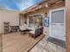 Charming back patio with cushioned seating, awning with string lights, and stone tile entryway to the home at 500 N Jefferson Ave # A3, Sarasota, FL 34237