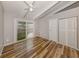 Light bedroom with updated doors, a fan, neutral walls, and glass sliding door to patio at 500 N Jefferson Ave # A3, Sarasota, FL 34237