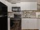 Updated kitchen with stainless steel appliances and decorative tile backsplash at 500 N Jefferson Ave # A3, Sarasota, FL 34237