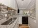 Bright kitchen with white cabinets, granite counters, and stainless dishwasher at 500 N Jefferson Ave # A3, Sarasota, FL 34237