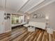 Bright living room with wood flooring, modern white sofa, views of patio, and vaulted ceilings with beams at 500 N Jefferson Ave # A3, Sarasota, FL 34237