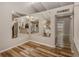 Open living space with wood floors, mirrored accent wall, and modern lighting at 500 N Jefferson Ave # A3, Sarasota, FL 34237