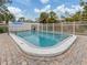 Community pool surrounded by white fencing, brick pavers and mature trees at 500 N Jefferson Ave # A3, Sarasota, FL 34237