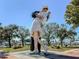 A view of the Unconditional Surrender Statue in Sarasota, Florida, with trees and a clear blue sky in the background at 500 N Jefferson Ave # A3, Sarasota, FL 34237
