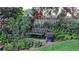 Lush backyard garden featuring a quaint bench, creating a serene and private outdoor escape at 512 W Venice Ave # 102, Venice, FL 34285