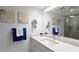 Bright bathroom featuring a vanity with granite countertop and glass-enclosed shower at 512 W Venice Ave # 102, Venice, FL 34285