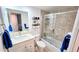 Well-lit bathroom featuring a sink with storage underneath and combined shower and tub at 512 W Venice Ave # 102, Venice, FL 34285