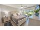 Bright bedroom with a queen-sized bed, dresser, a ceiling fan, and sliding glass doors to the outside at 512 W Venice Ave # 102, Venice, FL 34285