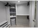 Organized walk-in closet providing ample storage space with shelving and hanging rods at 512 W Venice Ave # 102, Venice, FL 34285