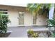 Condo entrance with side-by-side front doors, decorative windows, and tropical landscaping at 512 W Venice Ave # 102, Venice, FL 34285
