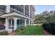 Exterior view with well-manicured lawn, showcasing the building's architectural details and landscaping at 512 W Venice Ave # 102, Venice, FL 34285