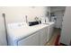Laundry room equipped with modern washer and dryer units for convenient in-building laundry access at 512 W Venice Ave # 102, Venice, FL 34285