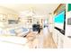 Bright living room features a ceiling fan, wood-look flooring, and comfortable seating for relaxing or entertaining at 512 W Venice Ave # 102, Venice, FL 34285