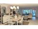 Bright living area with dining table and chairs with large sliders to a covered patio at 512 W Venice Ave # 102, Venice, FL 34285