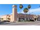 Venice Theatre exterior with striking architecture, including tall bell tower and palm trees at 512 W Venice Ave # 102, Venice, FL 34285