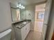 Bathroom with vanity and granite countertop, open to the bedroom at 519 Albee Farm Rd # 116, Venice, FL 34285