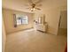 Bright bedroom with a ceiling fan, window, and tile flooring at 519 Albee Farm Rd # 116, Venice, FL 34285
