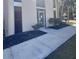 Building entrance with glass door, mature landscaping, and well-maintained sidewalk at 519 Albee Farm Rd # 116, Venice, FL 34285