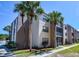 Condo exterior showcases a well-maintained building with lush landscaping and inviting screened-in balconies at 519 Albee Farm Rd # 116, Venice, FL 34285