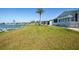 Spacious backyard featuring a view of the lake and a community dock at 6037 Shearwater Dr, Englewood, FL 34224