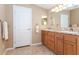 Bright bathroom featuring double sink vanity with granite countertop and white paneled door at 6037 Shearwater Dr, Englewood, FL 34224