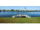 Scenic waterfront home featuring a private dock with an American flag and seating at 6037 Shearwater Dr, Englewood, FL 34224