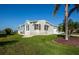 Bright single Gathering home with a manicured lawn and mature landscaping at 6037 Shearwater Dr, Englewood, FL 34224