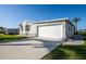 Single Gathering home with a two-car garage and an extra-long driveway on a sunny day at 6037 Shearwater Dr, Englewood, FL 34224