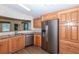 Well-lit kitchen with stainless steel appliances, wood cabinetry, and granite countertops at 6037 Shearwater Dr, Englewood, FL 34224