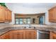 Bright kitchen featuring wood cabinets and a view to the living area at 6037 Shearwater Dr, Englewood, FL 34224
