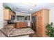 Charming kitchen with wood cabinets, stainless steel appliances, and granite countertops at 6037 Shearwater Dr, Englewood, FL 34224