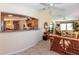 Open-concept living room boasts bright natural light, comfortable wicker furniture, and access to the kitchen at 6037 Shearwater Dr, Englewood, FL 34224