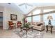 Bright living room features vaulted ceiling, large windows, and comfortable neutral furniture at 6037 Shearwater Dr, Englewood, FL 34224