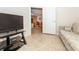 Cozy living room features tile floors, TV, and a view of the dining area, creating an inviting and connected living space at 6037 Shearwater Dr, Englewood, FL 34224